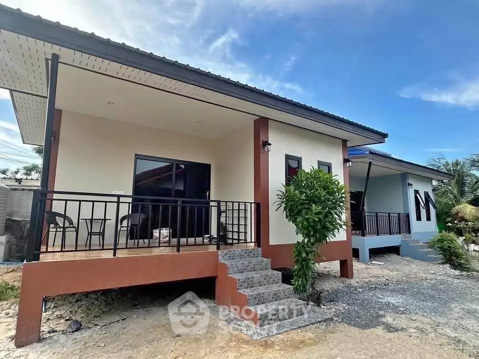 Charming modern bungalow with elevated porch and stylish exterior design, perfect for serene living.