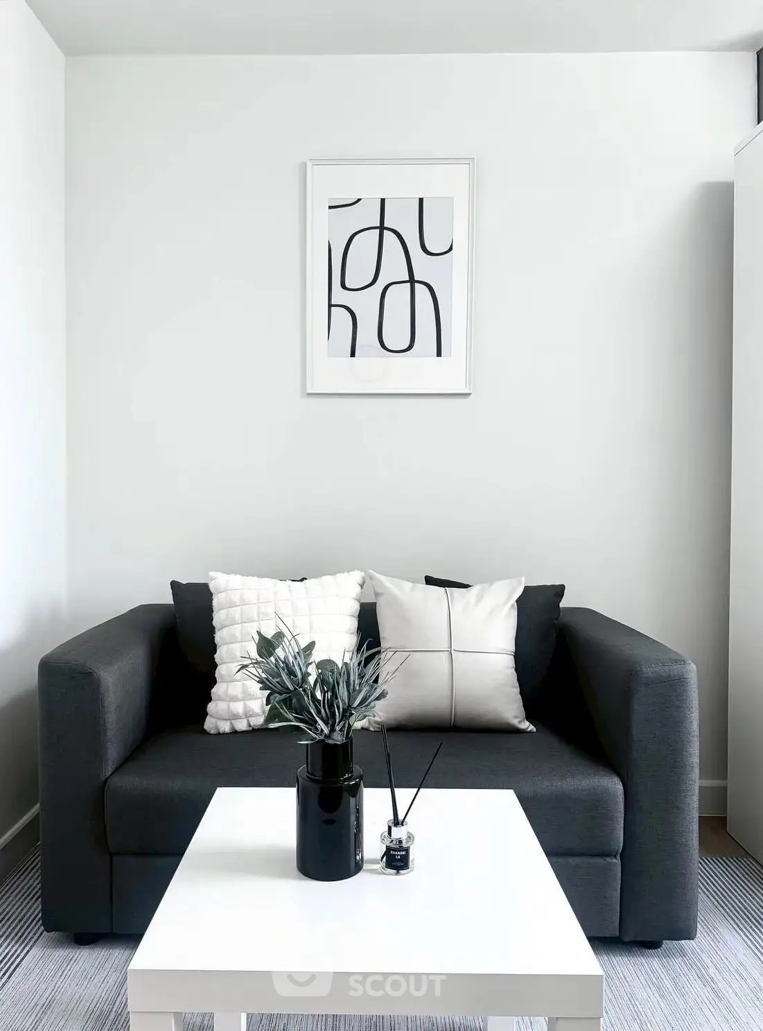 Modern living room with stylish sofa and abstract art, perfect for contemporary urban living.
