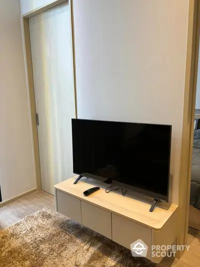 Modern living room with sleek TV stand and cozy carpet