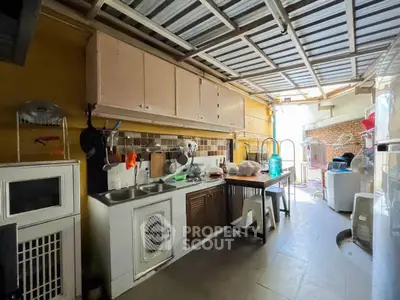 Charming kitchen with open layout and ample natural light, featuring modern appliances and rustic decor.