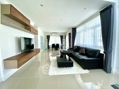 Spacious modern living room with sleek furniture and large windows