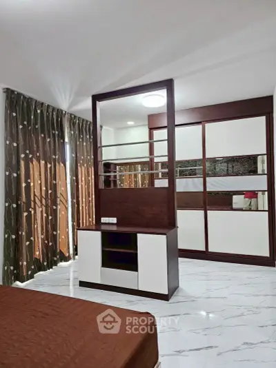 Modern bedroom with stylish partition and elegant wardrobe design.