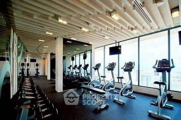 Modern gym with city view and state-of-the-art equipment in luxury building.