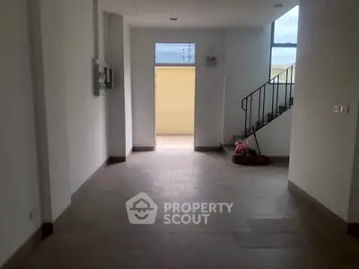 Spacious interior with staircase and large window, ideal for modern living.