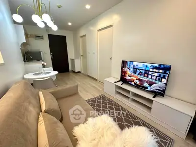 Modern living room with cozy sofa, stylish lighting, and flat-screen TV in a chic apartment.