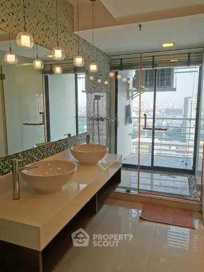 Luxurious bathroom with dual sinks and city view from glass shower