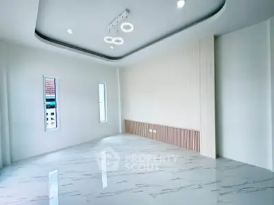 Modern minimalist living room with marble flooring and stylish ceiling lights.