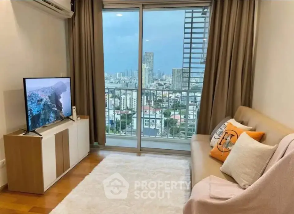 Modern living room with city view, cozy sofa, and large TV, perfect for relaxation.