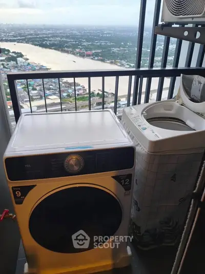 High-rise balcony with washing machines and stunning river view