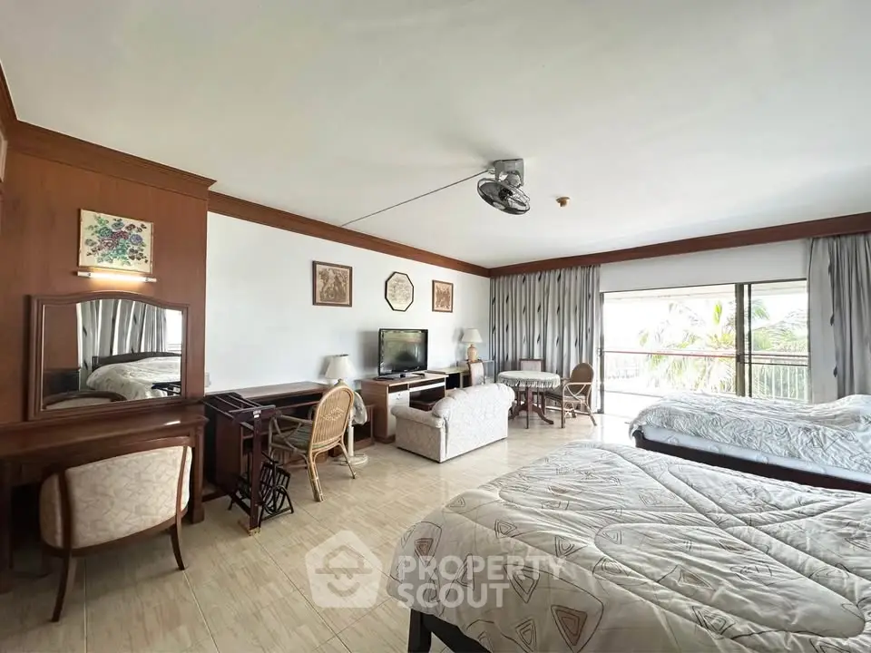 Spacious bedroom with elegant decor and balcony view