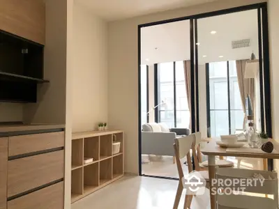 Modern open-plan kitchen and dining area with natural light and stylish decor.