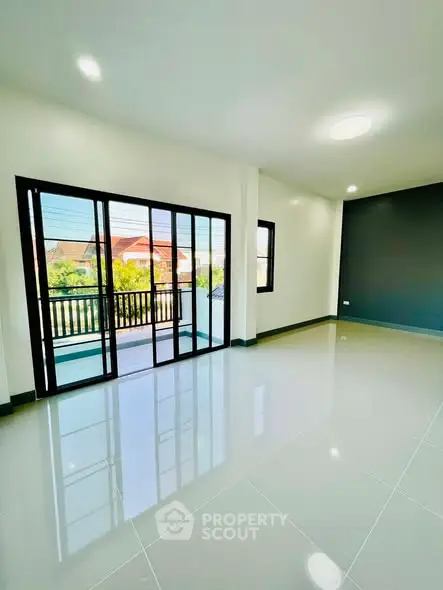 Spacious modern living room with large windows and balcony access