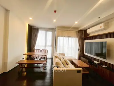 Spacious modern living room with elegant decor and large windows.