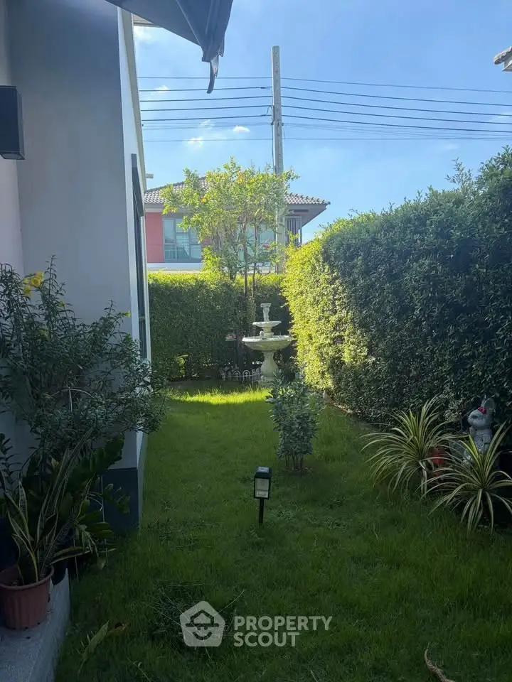 Charming garden view with lush greenery and a decorative fountain, perfect for relaxation and outdoor enjoyment.