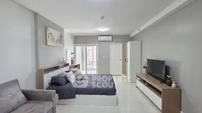 Spacious modern bedroom with stylish decor and ample natural light