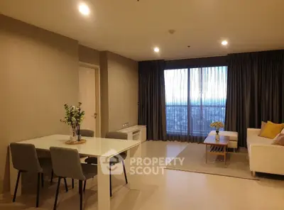 Spacious modern living room with dining area and large window view