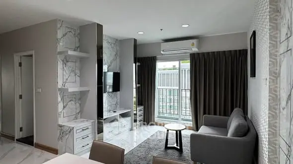 Modern living room with marble accents and balcony view