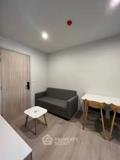 Modern living room with cozy sofa and dining area in a stylish apartment.