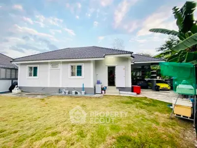 Charming single-story home with spacious yard and modern exterior design.