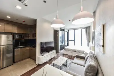 Modern open-plan living room with kitchen and bedroom in a stylish apartment