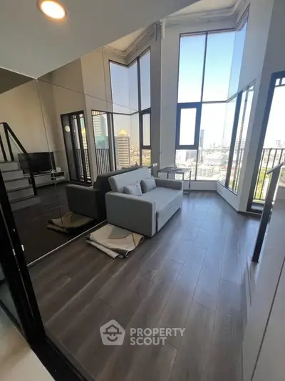 Modern living room with floor-to-ceiling windows and city view