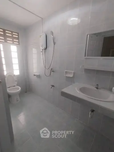 Spacious bathroom with modern fixtures and natural light
