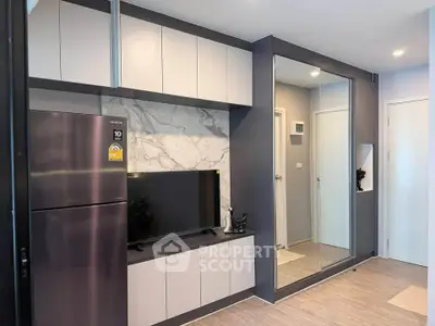 Modern living room with sleek cabinetry and large mirror