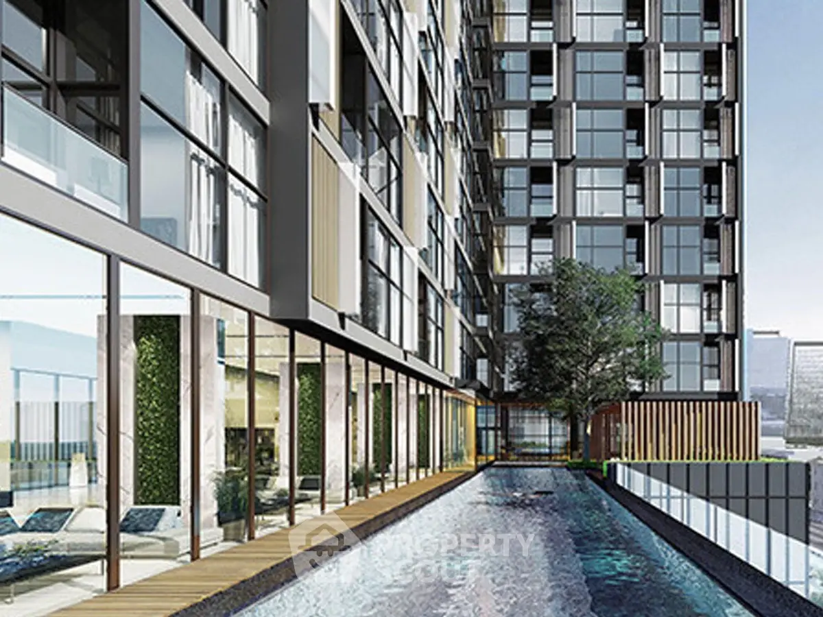 Modern high-rise building with sleek poolside area and contemporary design.