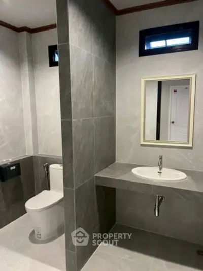 Modern bathroom with sleek gray tiles and minimalist design