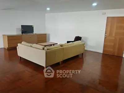 Spacious living room with wooden flooring and modern furniture