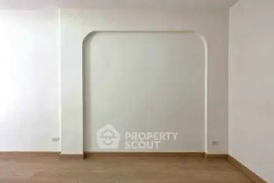 Minimalist interior wall with arch detail in modern apartment
