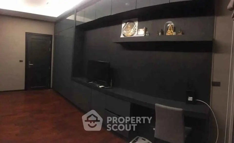 Modern study room with sleek black cabinetry and hardwood floors
