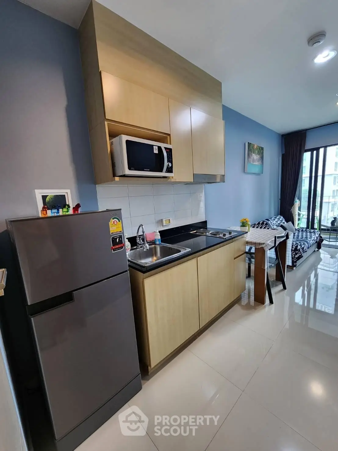 Modern kitchen with sleek cabinets and dining area in stylish apartment
