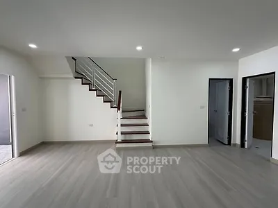 Spacious modern living room with sleek staircase and minimalist design