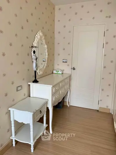 Charming vintage-style bedroom corner with elegant dresser and mirror, perfect for cozy living.
