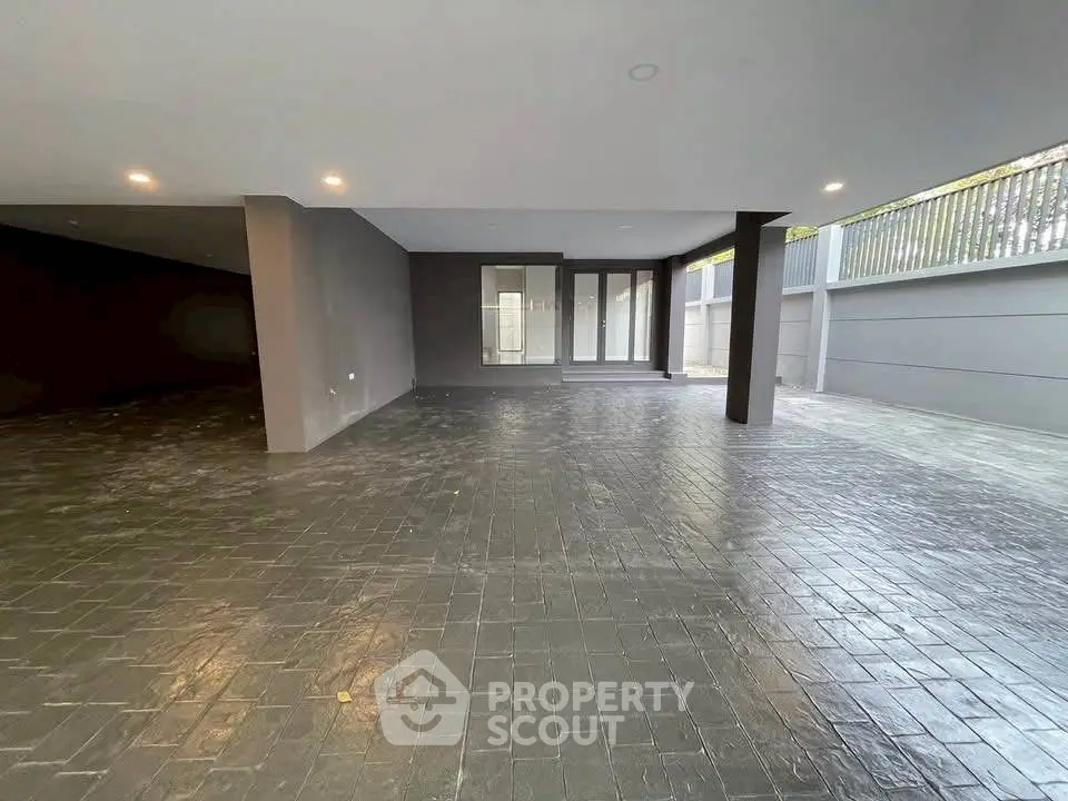 Spacious covered parking area with modern design and ample lighting.