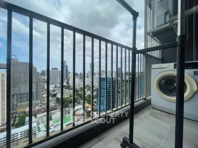 High-rise balcony with city view and washing machine, perfect urban living.