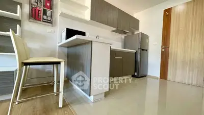 Modern kitchen with sleek cabinets and stainless steel appliances in a stylish apartment.