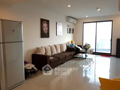 Spacious living room with modern decor and large sofa, perfect for relaxation.