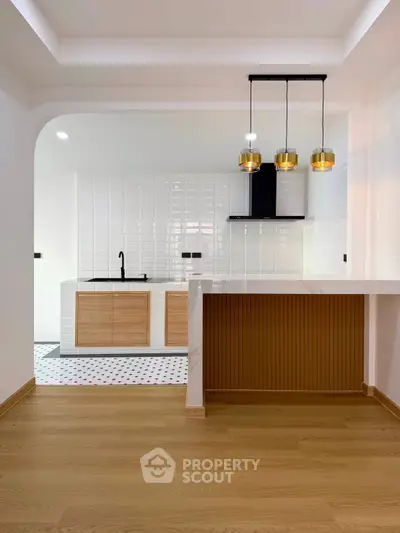 Modern kitchen with open layout and stylish lighting fixtures