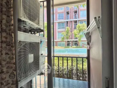 Modern apartment balcony with air conditioning units and pool view