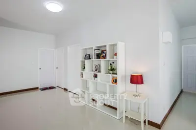 Spacious modern living room with elegant shelving and ambient lighting