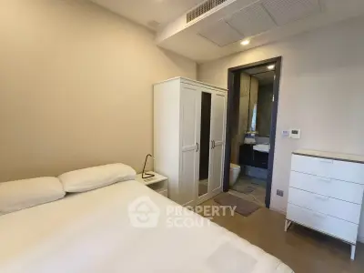 Modern bedroom with ensuite bathroom and stylish furniture