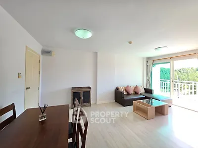 Spacious living room with modern furniture and large windows offering natural light.