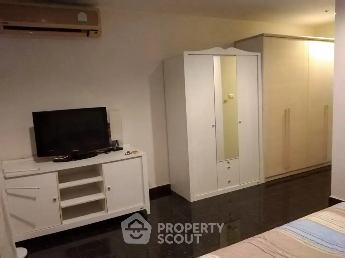 Cozy bedroom with modern furniture and sleek black flooring