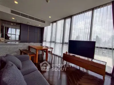 Luxurious modern living room with panoramic city views and elegant furnishings.