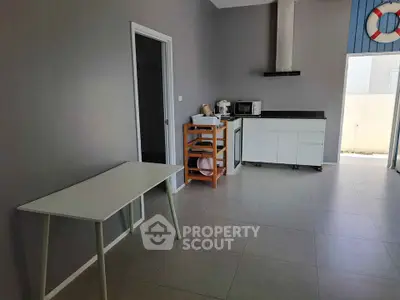 Modern kitchen with sleek design and open layout, featuring minimalist furniture and appliances.