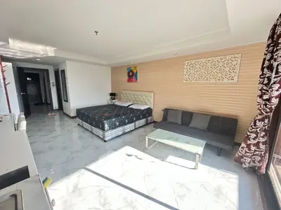 Spacious bedroom with modern decor and ample natural light