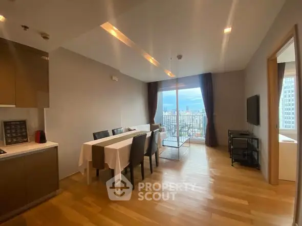 Modern dining area with city view and balcony access in a stylish apartment.