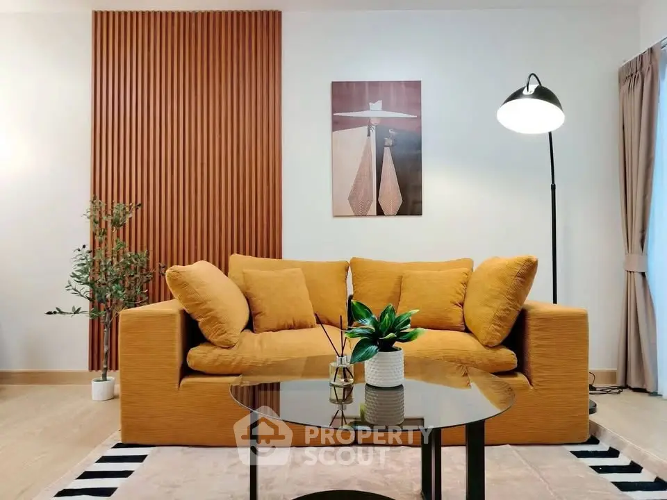 Stylish living room with modern decor, featuring a cozy mustard sofa and elegant floor lamp.
